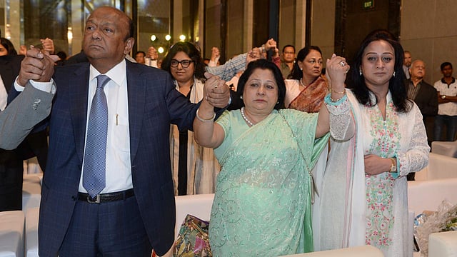 Transcom Group chairman Latifur Rahman (L) and his relatives hold hands as The Mother Teresa Memorial International Awards for Social Justice 2016 is awarded to his martyred grandson Faraaz Ayaaz Hossain at an award ceremony in Mumbai on 20 November 2016. Photo: AFP
