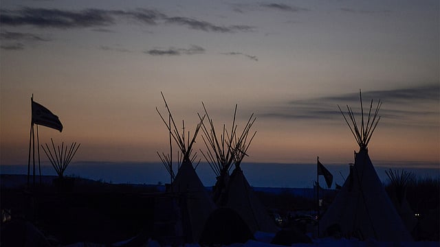 The tops of tipis are seen in Oceti Sakowin camp at sunset during a protest against plans to pass the Dakota Access pipeline near the Standing Rock Indian Reservation, near Cannon Ball, North Dakota, U.S. December 2, 2016. Photo: Reuters