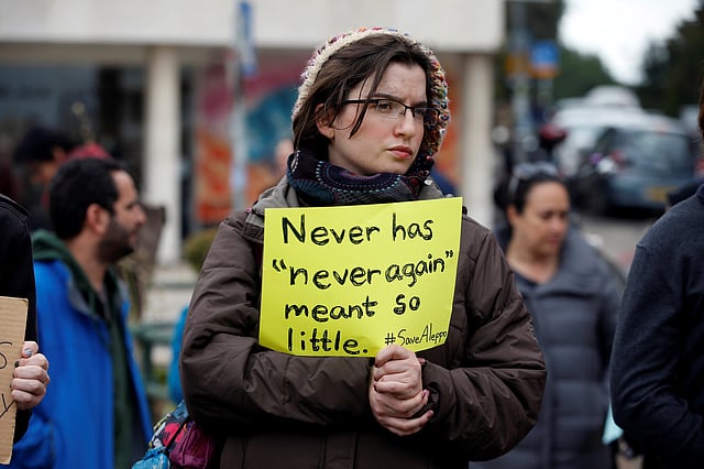An Israeli protester holds a sign during a demonstration to show solidarity with the citizens of Aleppo, Syria, outside the prime minister`s residence in Jerusalem. Photo: Reuters