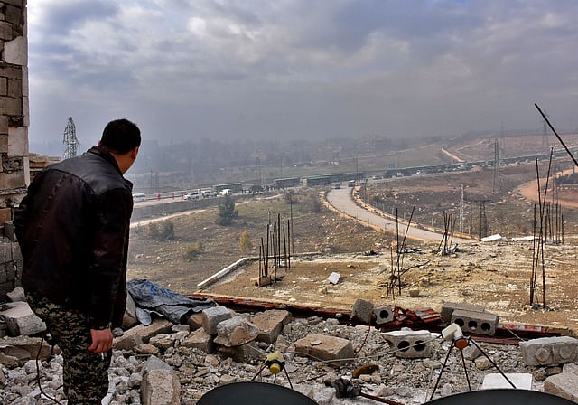 A member of the Syrian government forces wacthes during an evacuation operation of Syrian rebel fighters and civilians from a opposition-held area of Aleppo towards rebel-held territory in the west of Aleppo`s province. Photo: Reuters
