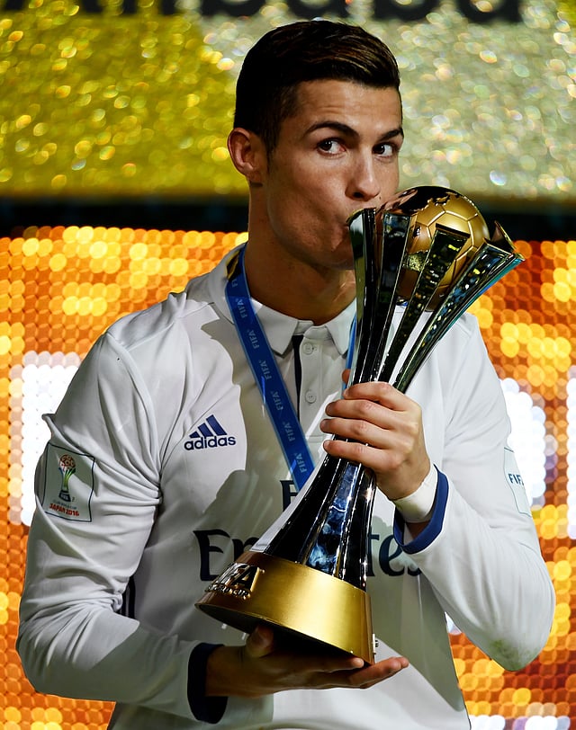 Real Madrid forward Cristiano Ronaldo kisses the champion trophy on the podium after they won the Club World Cup final against Kashima Antlers at Yokohama International Stadium on Sunday. AFP