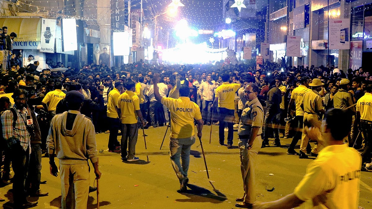 Indian police personnel holding ‘lathi’ sticks as they attempt to manage crowds during New Year’s Eve celebrations in Bangalore. AFP file photo