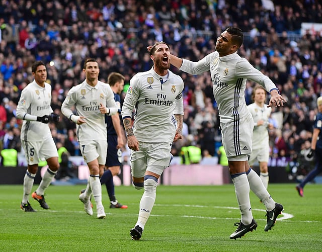 Real Madrid’s defender Sergio Ramos (L) celebrates with Real Madrid’s Brazilian midfielder Casemiro after scoring during the Spanish league football match Real Madrid CF vs Malaga CF at the Santiago Bernabeu stadium in Madrid. Photo: AFP