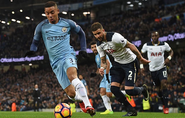 Manchester City’s Brazilian striker Gabriel Jesus (L) runs with the ball during the English Premier League football match between Manchester City and Tottenham Hotspur at the Etihad Stadium in Manchester