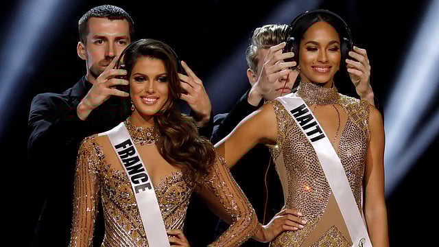 Headphones are placed on Miss France Iris Mittenaere and Miss Haiti Racquel Pellisier at the Mall of Asia Arena, in Pasay, Metro Manila. Reuters