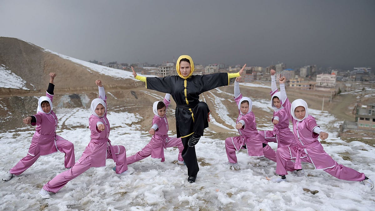 Afghan members of a Wushu martial arts group led by trainer Sima Azimi ©, 20, pose for a photograph at the Shahrak Haji Nabi hilltop overlooking Kabul. Photo: AFP
