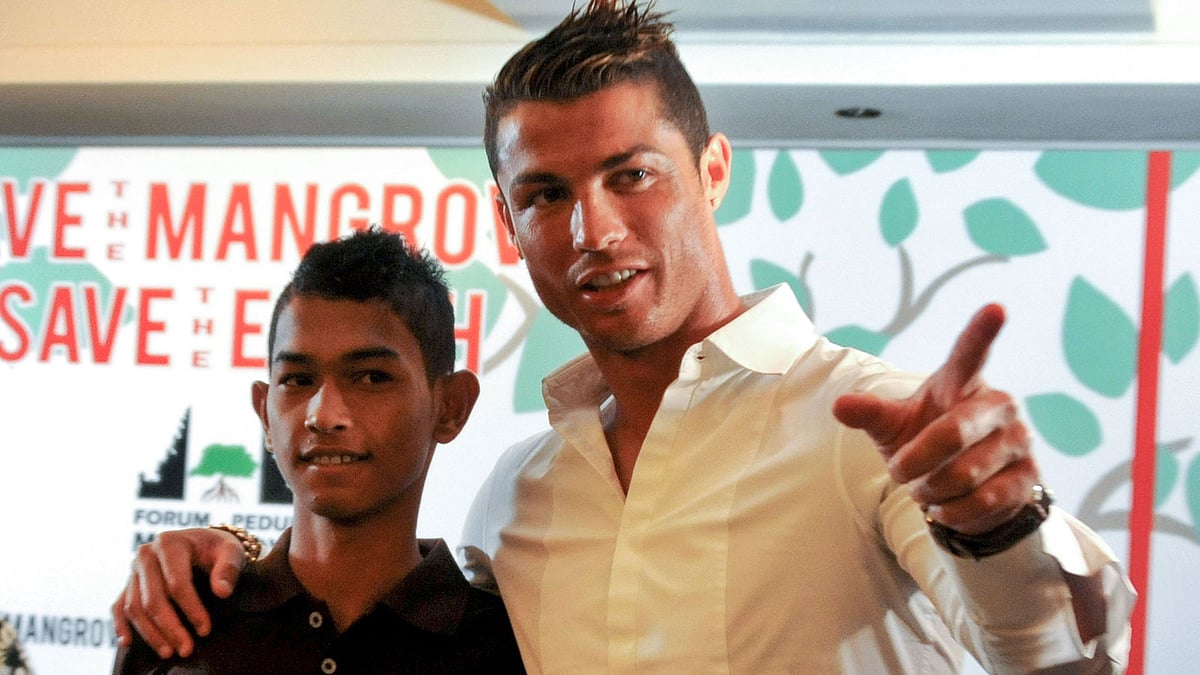 This file photo taken in Bali on June 26, 2013 shows football player Christiano Ronaldo (R) reunited with 16-year-old Martunis (L), an Indonesian survivor of the deadly 2004 Aceh tsunami who the Real Madrid star met in 2005 during a mission to assist tsunami victims and gave his family financial assistance. AFP