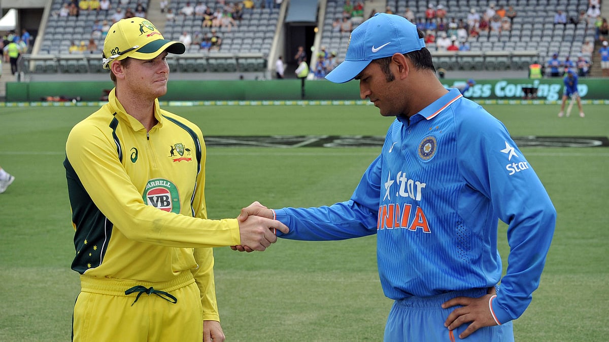 This file photo taken on January 20, 2016 shows Australia`s captain Steve Smith (L) and Indian captain MS Dhoni (R) shaking hands before starting the fourth one-day international cricket match between India and Australia at the Manuka Oval in Canberra. AFP
