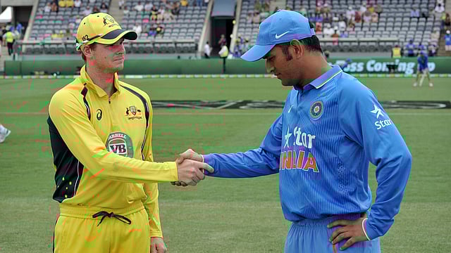 This file photo taken on January 20, 2016 shows Australia`s captain Steve Smith (L) and Indian captain MS Dhoni (R) shaking hands before starting the fourth one-day international cricket match between India and Australia at the Manuka Oval in Canberra. AFP