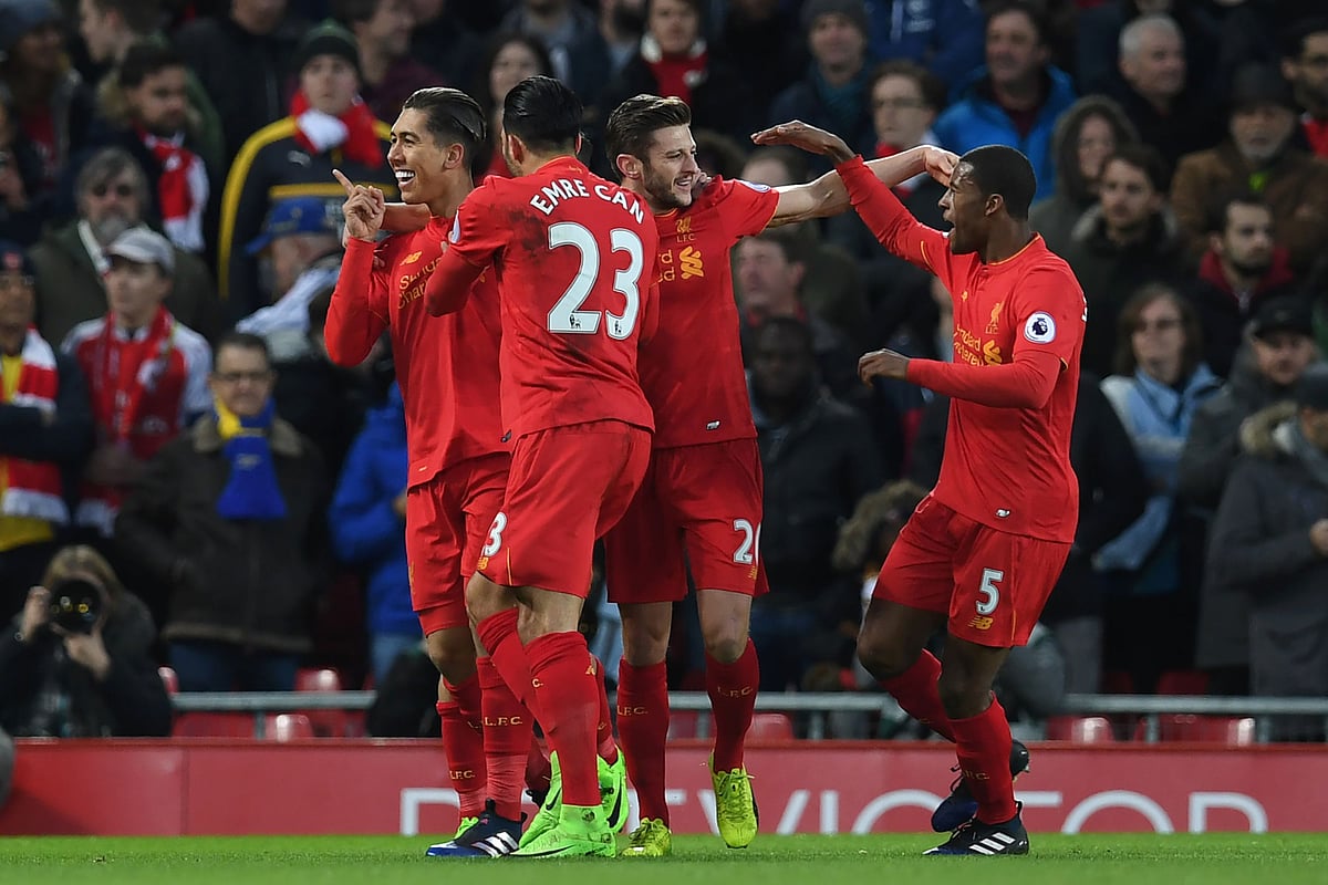 Liverpool’s Brazilian midfielder Roberto Firmino (L) celebrates with teammates after scoring the opening goal of the English Premier League football match between Liverpool and Arsenal at Anfield in Liverpool, north west England. Photo: AFP