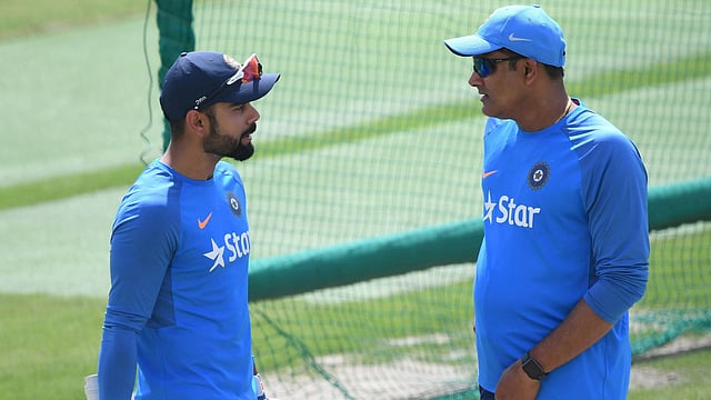This file photo taken on March 24 shows India coach Anil Kumble (R) talking with captain Virat Kohli during a training session on the eve of a Test match between India and Australia at the Himachal Pradesh Cricket Association Stadium in Dharamsala. AFP