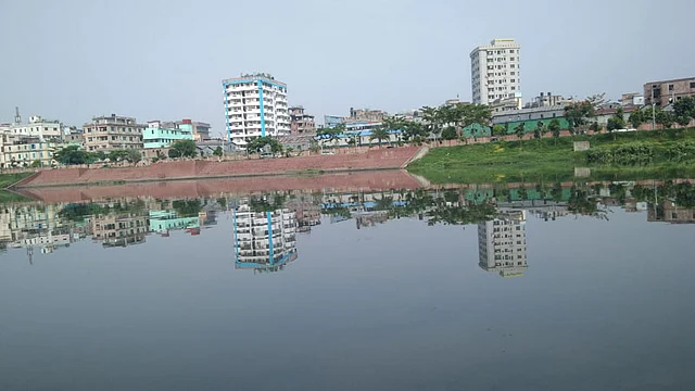Residential buildings are reflected on water of the artificial lake Hatijheel on 6 June 2017. Photo: Toriqul Islam