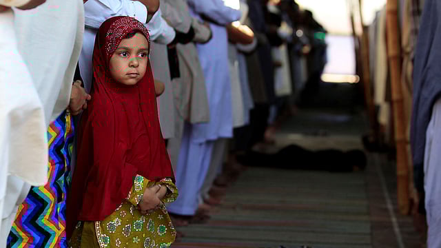 A girl attends last Friday prayers with others during the holy month of Ramadan in Rawalpindi, Pakistan. Photo:  Reuters