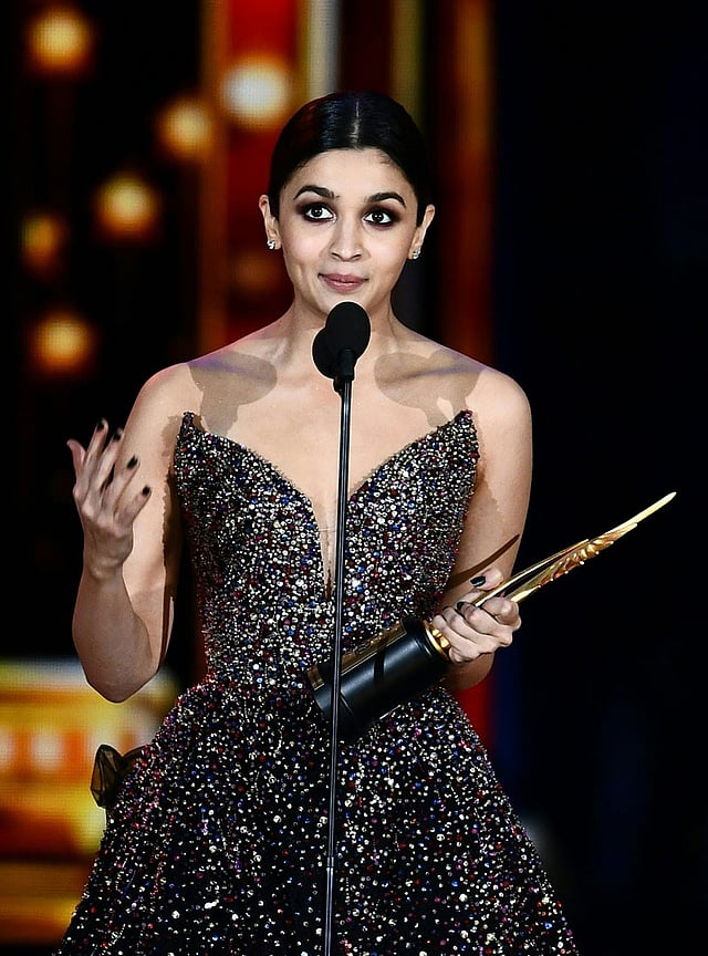 Alia Bhatt accepts her award for Best Actress on stage during the IIFA Awards 15 July, 2017 at the MetLife Stadium in East Rutherford, New Jersey during the 18th International Indian Film Academy (IIFA) Festival. Photo: AFP