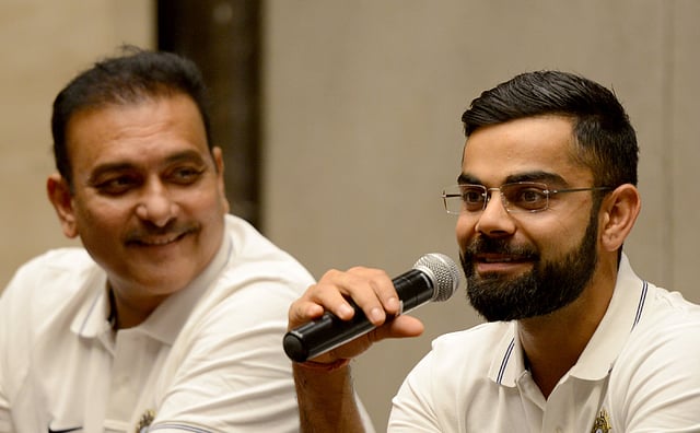 Indian cricket team captain Virat Kohli ® speaks as newly-appointed coach Ravi Shastri looks on during a news conference before the national team’s departure for Sri Lanka, in Mumbai. Photo: AFP