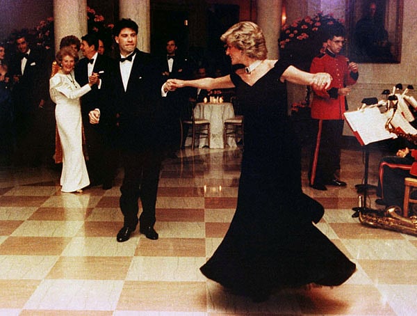 Princess Diana is shown wearing a Victor Edelstein gown as she dances at a 9 November, 1985 White House dinner with actor John Travolta, in Washington, USA. Photo: Reuters