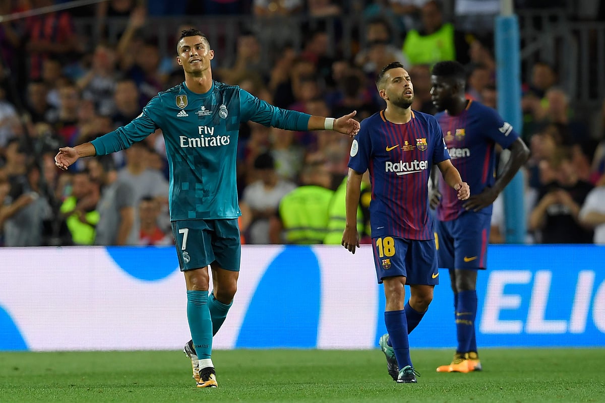 Real Madrid`s Portuguese forward Cristiano Ronaldo (L) gestures as he leaves the field after receiving his second yellow card during the Spanish Supercup first leg football match FC Barcelona vs Real Madrid at the Camp Nou stadium in Barcelona. Photo: AFP
