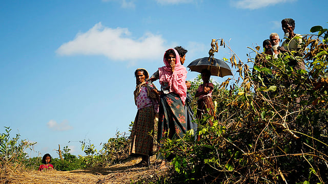 Rohingya people look on at a makeshift shelter in No Man’s Land after crossing the Bangladesh-Myanmar border fence, in Cox’s Bazar, Bangladesh, 29 August. Photo: Reuters