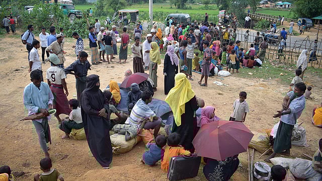 This August 29, 2017 photo shows Rohingya refugees fleeing from Myanmar resting at Kutupalong refugee camp along the Bangladesh-Myanmar border near the Bangladeshi town of Ukhiya. AFP