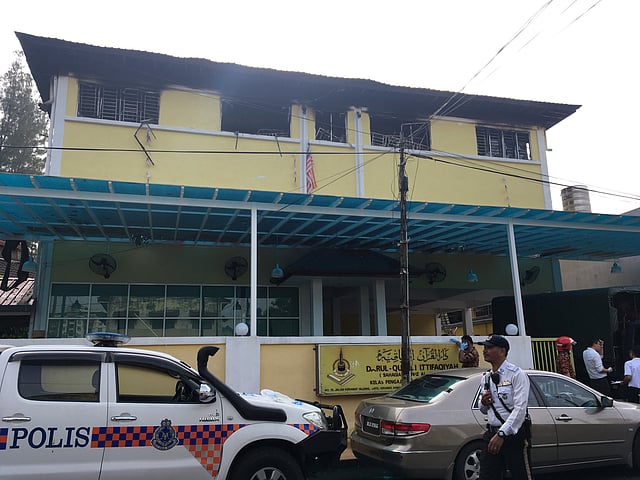 Police and fire department work at the religious school Darul Quran Ittifaqiyah after a fire broke out in Kuala Lumpur. Photo: Reuters