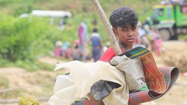 Yasmida stands with her baggage under the open sky near Balukhali camp on Wednesday. Photo: Abdus Salam