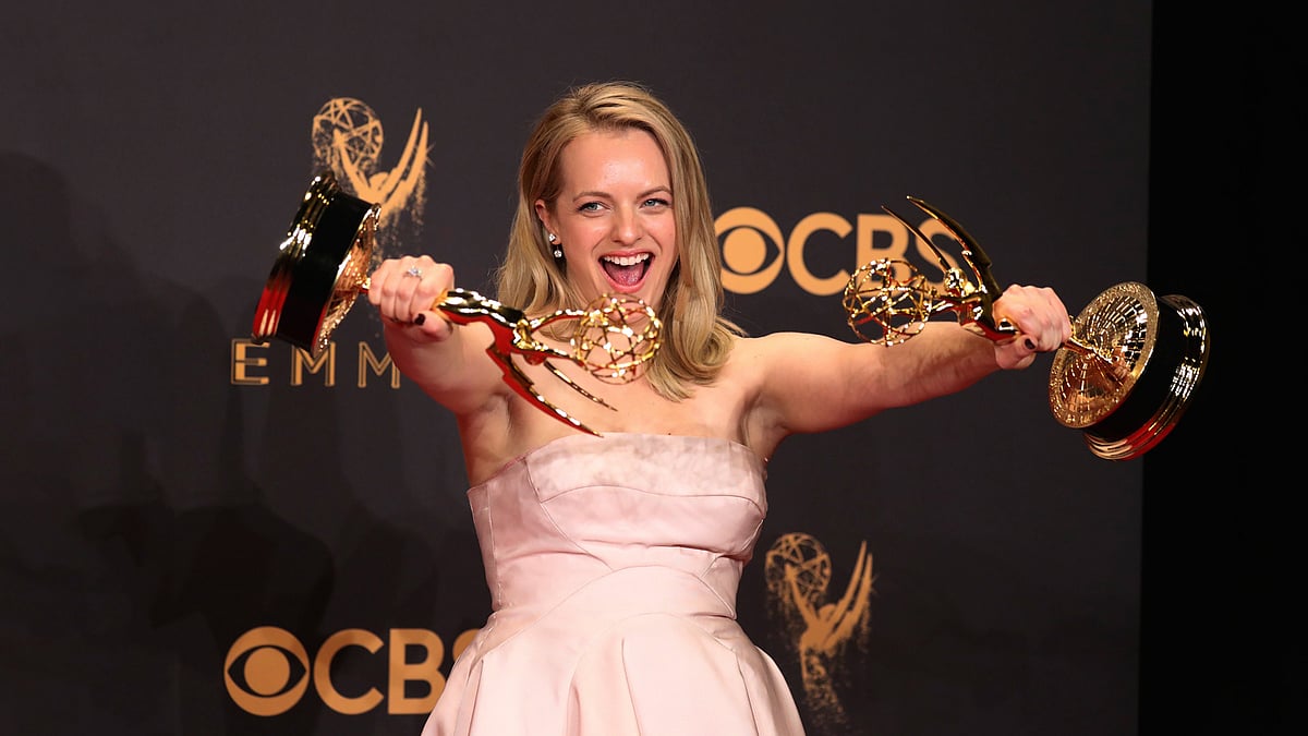 Elizabeth Moss poses backstage with her awards for Outstanding Lead Actress in a Drama Series and Outstanding Drama Series for `The Handmaid`s Tale`. Photo: Reuters