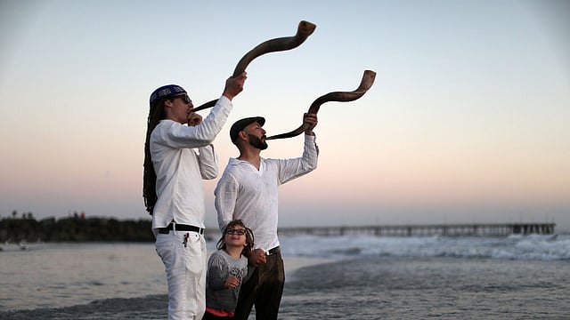 Stein and Levitch blow the shofar at a Tashlich ceremony during the Nashuva Spiritual Community Jewish New Year celebration on Venice Beach in Los Angeles. Reuters