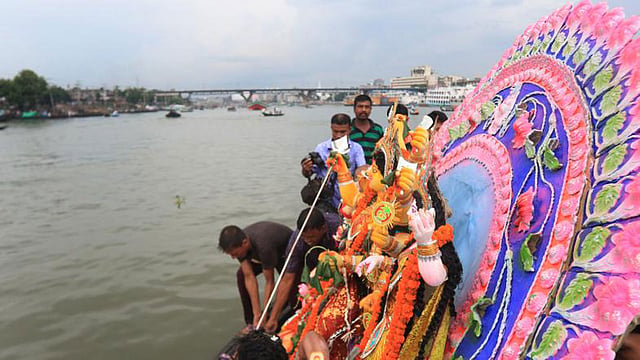 Hindu devotees taking the idol of Goddess Durga at Buriganga river for immersion on Saturday. Photo: Ashraful Alam