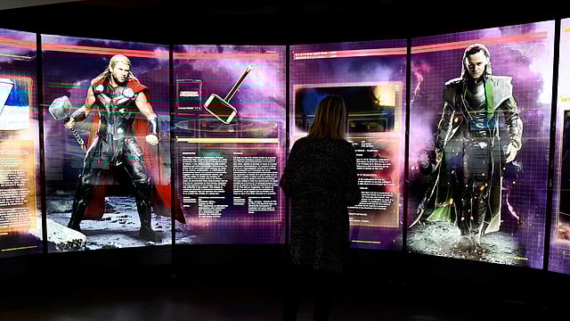 This file photo taken on 13 April, 2016 shows a visitor looks at a display on Marvel Comics superhero `Thor` (L) and character `Loki` at the interactive Marvel Avengers STATION exhibition in the bussines district of La Defense, west of Paris. Photo: AFP