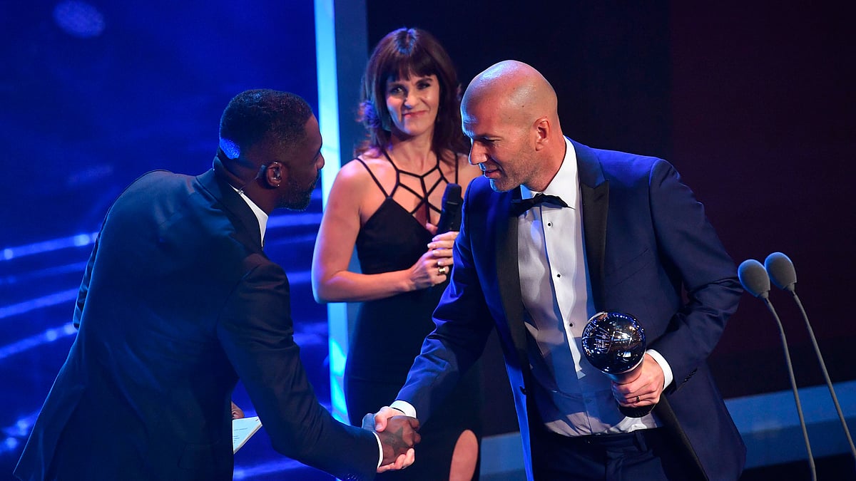 British actor Idris Elba (L) shakes hands with Real Madrid`s French coach Zinedine Zidane after Zidane wins The Best FIFA Men`s Coach of 2017 Award during The Best FIFA Football Awards ceremony, on October 23, 2017 in London. AFP