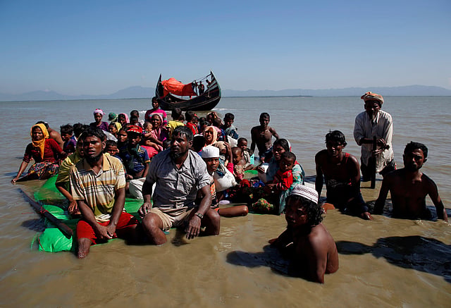Rohingya refugees sit on a makeshift boat as they get interrogated by the Border Guard Bangladesh after crossing the Bangladesh-Myanmar border, at Shah Porir Dwip near Cox's Bazar. Reuters