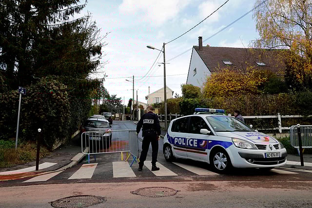 Police officers patrol next to red chemical dust left over blood stains from a crime scene, in which a police officer killed two passerbyes, then later killed the father of his girlfriend, before finally committing suicide. Photo: AFP