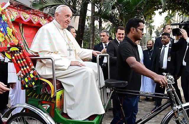 Pope Francis takes a ride in a rickshaw during the second day of his visit to Bangladesh, in Dhaka on 1 December, 2017. Photo: AFP