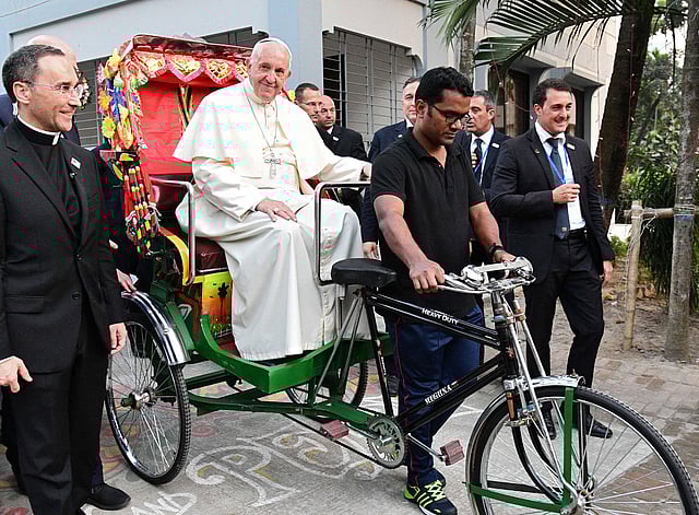 Pope Francis takes a ride in a rickshaw during the second day of his visit to Bangladesh, in Dhaka on 1 December, 2017. Photo: AFP