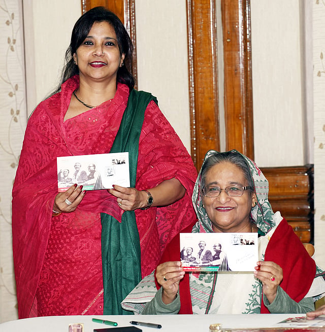 Prime minister Sheikh Hasina and state minister for posts and telecommunications Tarana Halim show a commemorative postage stamp. Photo: BSS