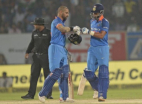 Indian cricket batsmen Shreyas Iyer (R) and Shikhar Dhawan (C) gesture during the third One Day International (ODI) cricket match between India and Sri Lanka at the Dr. Y.S. Rajasekhara Reddy ACA-VDCA Cricket Stadium in Visakhapatnam on December 17, 2017. AFP