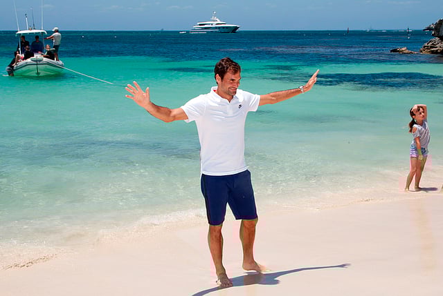 Swiss tennis player Roger Federer walks along a beach at Rottnest Island off the coast of Western Australia on December 28, 2017. AFP