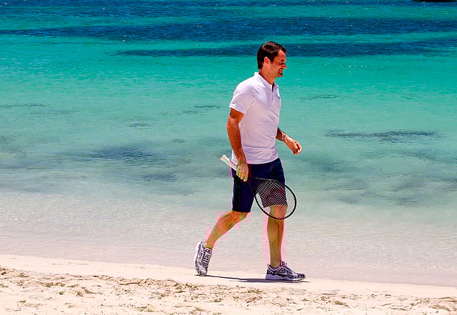 Swiss tennis player Roger Federer walks along a beach at Rottnest Island off the coast of Western Australia on December 28, 2017. AFP