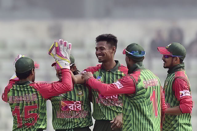 Bangladeshi cricketer Mustafizur Rahman (C) celebrates after the dismissal of Zimbabwe's Brendan Taylor during the first One Day International (ODI) cricket match of the Tri-Nations Series between Bangladesh and Zimbabwe at the Sher-e-Bangla National Cricket Stadium in Dhaka on 15 January 2018. AFP