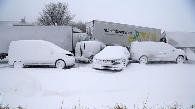 Several trucks and cars, covered with snow, stand deserted after a pileup on Tuesday near Sjobo, southern Sweden. Photo: AFP