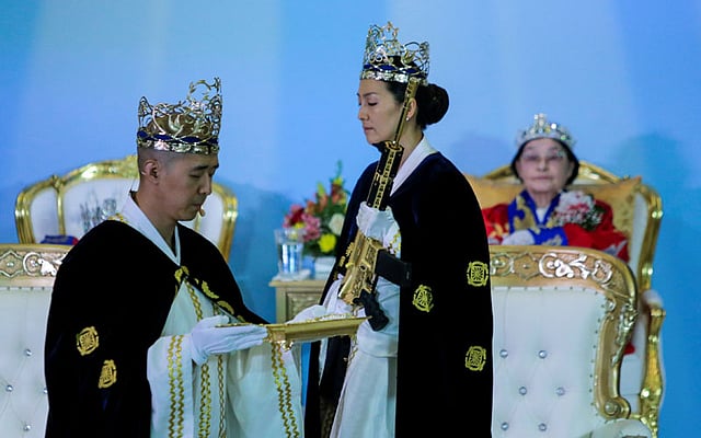 Reverend Hyung Jin Moon, the church`s pastor and the son of the late Sun Myung Moon, attends a ceremony while people with their AR-15-style rifles in their cases watch the event at the Sanctuary Church in Newfoundland, Pennsylvania, US, 28 February. Photo: Reuters