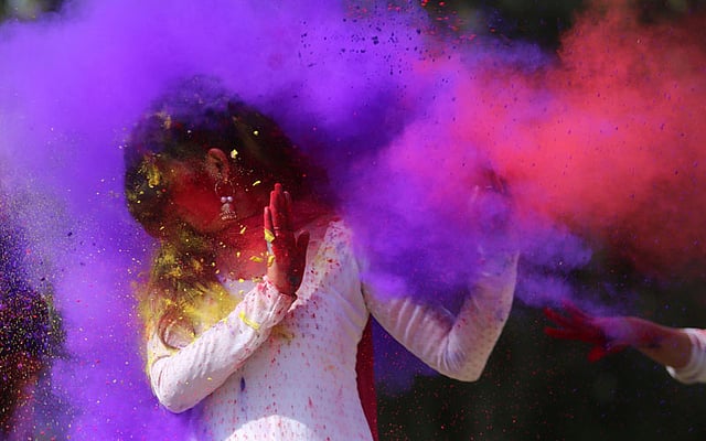 Indian college girls throw coloured powder to one another during Holi festival celebrations in Bhopal on 28 February. Photo: AFP
