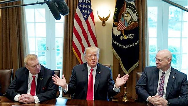 Chairman, CEO and president of Nucor John Ferriola and U.S. Steel CEO Dave Burritt flank U.S. President Donald Trump as he announces that the United States will impose tariffs of 25 per cent on steel imports and 10 per cent on imported aluminium during a meeting at the White House in Washington, U.S., on 1 March 2018. Reuters