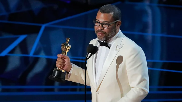 Jordan Peele accepts the Oscar for Best Original Screenplay for `Get Out.` Photo: Reuters