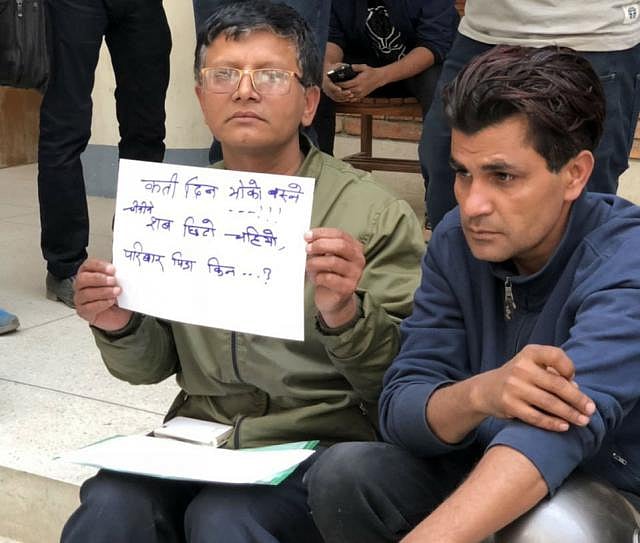 Holding placards inscribed with the names of the plane crash victims, relatives wait in front of the morgue of the Kathmandu Medical College Teaching Hospital. Photo was taken by Kamrul Hasan on Wednesday.