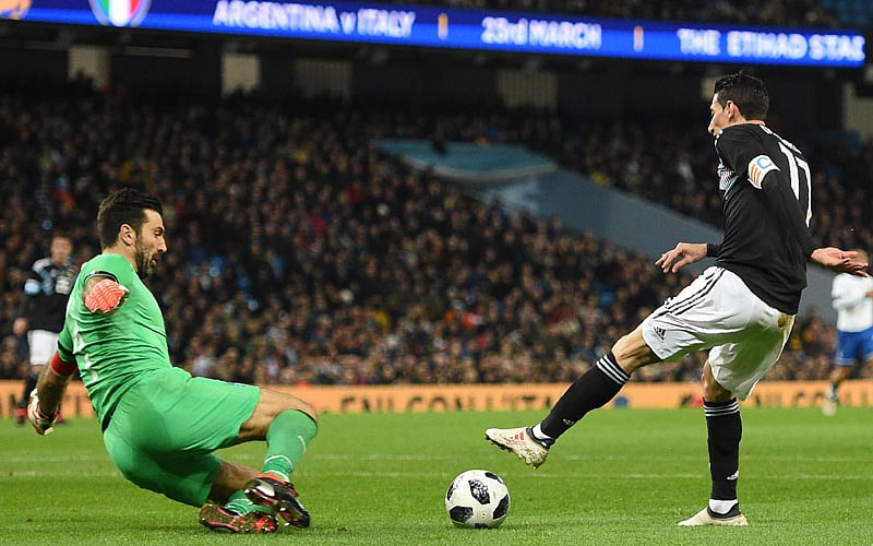 Italy goalkeeper Gianluigi Buffon (L) comes out to save from Argentina midfielder Angel Di Maria during an international friendly at the Etihad Stadium in Manchester on Friday. AFP