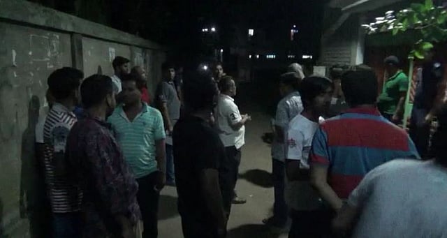 People gather in front of the house of Faridpur town where female college teacher, bank officer found dead. Photo: UNB