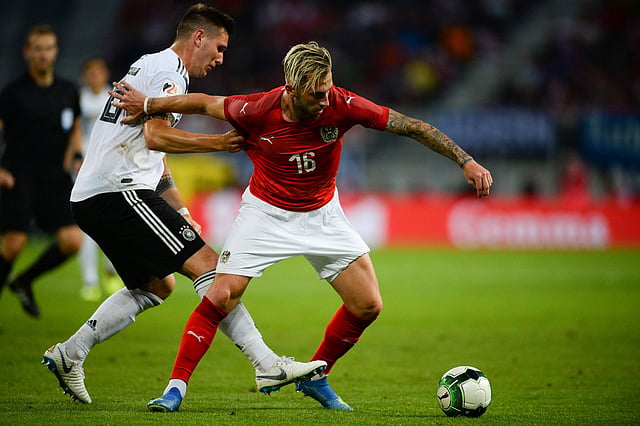 Austria`s midfielder Peter Zulj (R) and Germany`s defender Niklas Suele vie for the ball during the international friendly footbal match in Klagenfurt, Austria, on 2 June 2018. Photo: AFP