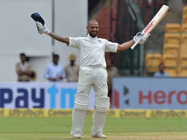India`s batsman Shikhar Dhawan celebrates his century (100 runs) during the first day of the one-off cricket Test match against Afghanistan at The M Chinnaswamy Stadium in Bangalore on 14 June 2018. Photo: AFP