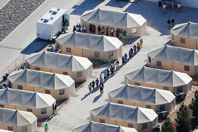 Immigrant children now housed in a tent encampment under the new `zero tolerance` policy by the Trump administration are shown walking in single file at the facility near the Mexican border in Tornillo, Texas, US on 19 June 2018. Photo: Reuters